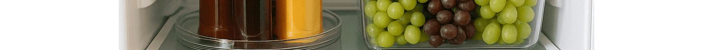 Organised fridge with fresh fruits and vegetables in clear storage containers