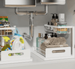 Under-sink storage with organised cleaning supplies and toiletries in sliding drawers.