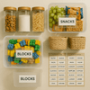 Organised pantry storage with labeled containers and baskets for toys and snacks.