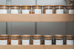 Organised spice jars on wooden pantry shelves for efficient home organisation and pantry storage.