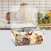 Transparent multi-use storage box with removable dividers in a kitchen, organizing pantry items.