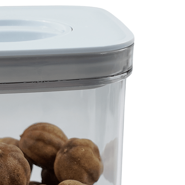 Clear kitchen storage container with white twist lid, perfect for pantry or fridge organization.