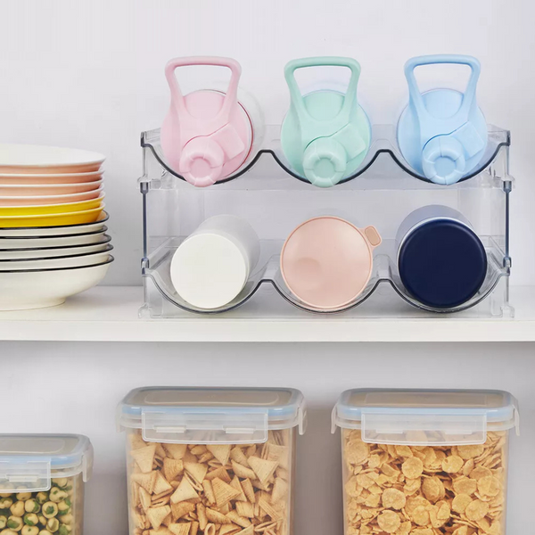 Stacked clear bottle organiser with colorful lids and cereal containers, ideal for kitchen or pantry storage, promoting space efficiency.