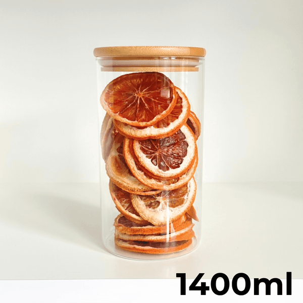 Round glass bamboo storage jar, 1400ml, ideal for pantry organization with dried fruits shown inside.