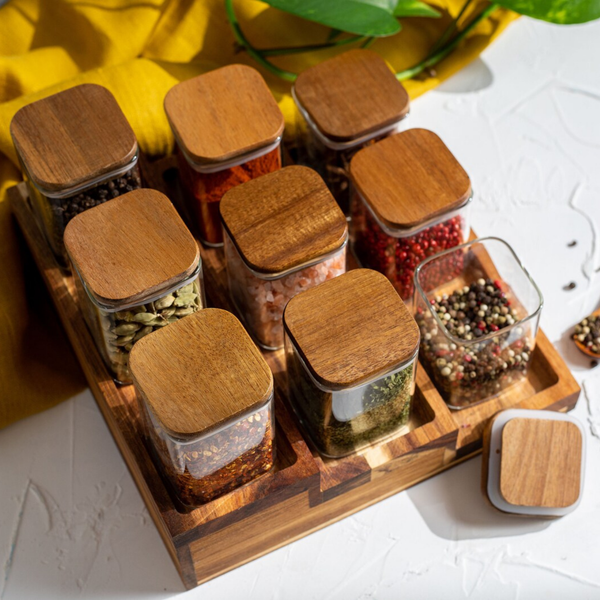 Square acacia spice jars with wooden lids on a tray, perfect for kitchen and pantry storage. Stylish home organisation and space-saving solution.