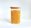 Square bamboo glass storage container filled with pasta, ideal for pantry organization.
