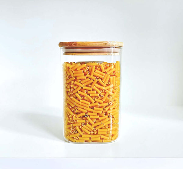 Glass jar filled with pasta, part of Square Bamboo Pantry Jars – 12-Pack Glass Storage Set, ideal for pantry organisation.