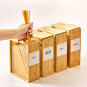 Hand using Bamboo Food Dispenser – 3L for storing pasta, ideal for kitchen and pantry organisation, featuring a sleek design.