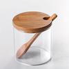 Glass jar with bamboo lid and spoon, perfect for kitchen storage and organization, highlighting style and functionality.