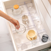Small Clear Drawer Organisers used for efficient kitchen storage, holding mugs and glasses neatly in a pull out drawer.