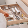 Small Clear Drawer Organisers holding kitchen utensils for optimal drawer space management.