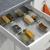 Expandable In-Drawer Spice Rack neatly organising glass jars for efficient kitchen and pantry storage.