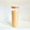 Glass jar from Round Bamboo Glass Pantry Container Set – 35 Pack used for storing rice in kitchen pantry.
