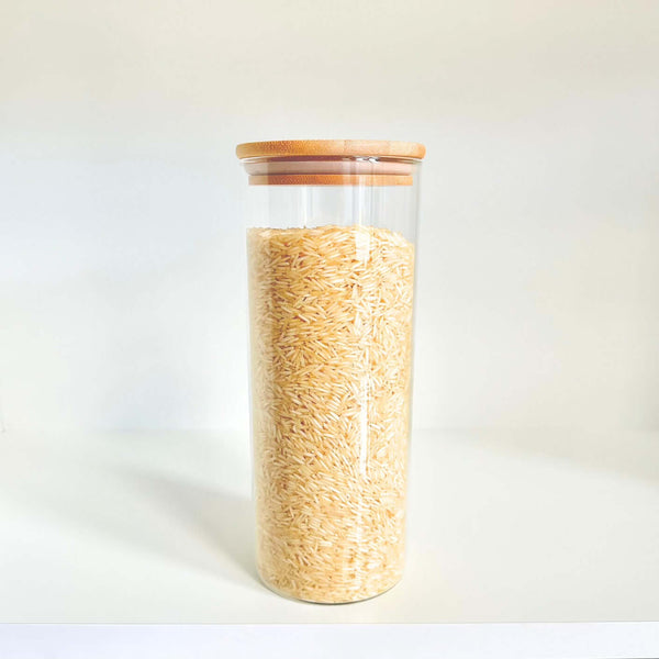Glass jar from Round Bamboo Glass Pantry Container Set – 35 Pack used for storing rice in kitchen pantry.