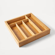 Wooden drawer organizer with compartments on a white background