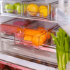 Clear modular drawer organizer with fruits in fridge, perfect for space-saving storage solutions.
