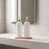 White Plastic Pump Bottles + Bamboo Tray – 500 ml Set on bathroom counter, ideal for kitchen organisation and storage.