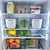 Transparent fridge containers, part of 13-pack storage organiser, holding fruits and vegetables for efficient kitchen use.