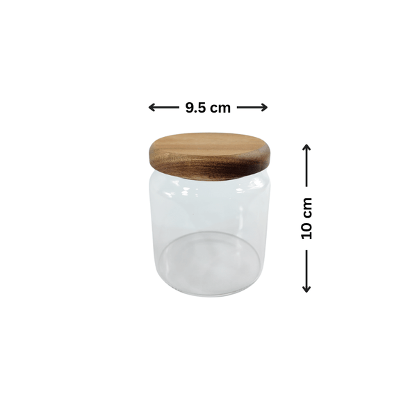 Transparent 600ml glass jar with acacia wood lid for kitchen storage and organization.