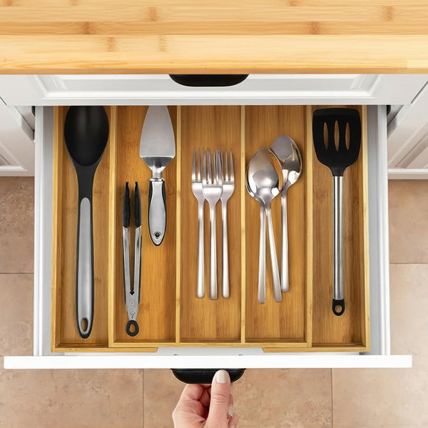 Bamboo Expandable Cutlery Drawer Insert used for efficient kitchen organisation with neatly arranged utensils in a cutlery drawer.