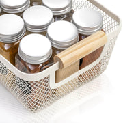 White Mesh Storage Basket with Wooden Handles filled with glass jars, ideal for kitchen and pantry organisation, enhancing storage space.