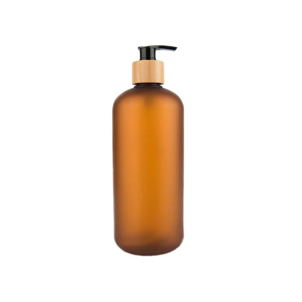 Amber glass bottle with a pump dispenser on a white background
