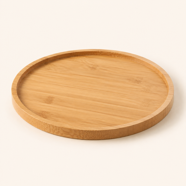 A round bamboo serving tray with a natural light wood grain, shown from a slightly elevated angle on a clean, solid off-white background.
