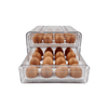 Two-level egg organiser drawer for fridge storage, clear plastic, space-saving kitchen solution.