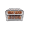 Transparent two-level egg organiser drawer for fridge storage and kitchen space-saving.