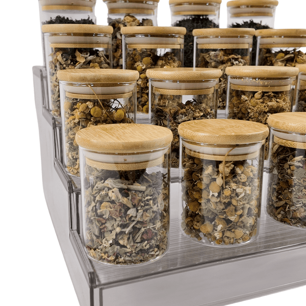 Expandable clear spice rack with pantry jars for kitchen storage and organization.