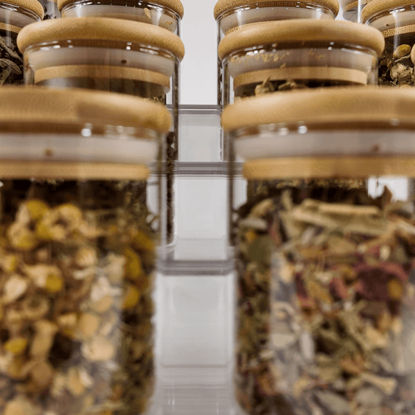 Bamboo lid jars filled with herbs, ideal for pantry storage and home organisation in Australia.
