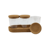 Glass storage jar trio with cork lids for pantry or fridge organization.