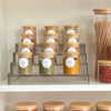 Set of 12 bamboo spice jars with glass bodies, perfect for pantry or kitchen storage organisation.