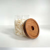Round glass storage jar with acacia lid, ideal for pantry or kitchen organization.