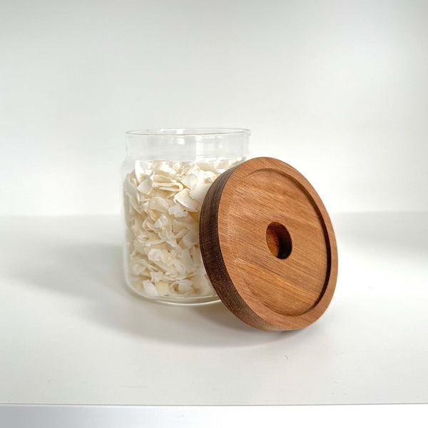 Round glass storage jar with acacia lid, ideal for pantry or kitchen organization.