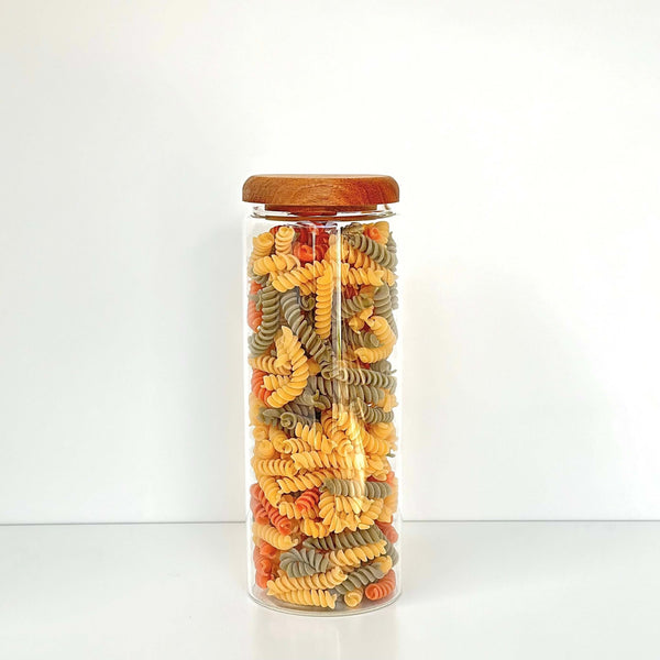 Glass storage jar with acacia lid for pantry, storing colorful pasta; 1500ml, space-saving.