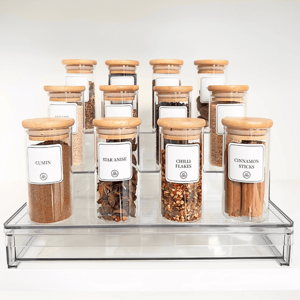 Acrylic spice rack with 12 bamboo-lidded jars for stylish kitchen organisation. Perfect pantry storage solution for spices.
