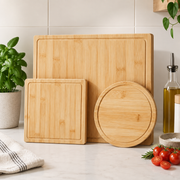 Set of 3 Bamboo Cutting Boards leaning on a kitchen bench beside tomatoes