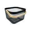 Small black storage basket with wooden handle, ideal for pantry or kitchen organization.