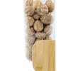 Transparent glass storage jar with bamboo lid filled with nuts; perfect for pantry organization.