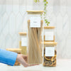 Hand holding glass jar labeled pasta; part of Small Pantry Reset Pack for kitchen and pantry organisation.