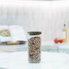 Round Glass Acacia Storage Jar Set – 5 Pack displayed on a kitchen countertop, ideal for pantry organisation with glass jars.