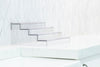 Expandable 4-Tier Clear Spice Rack Organiser on a white kitchen counter, ideal for pantry organisation and maximising storage.