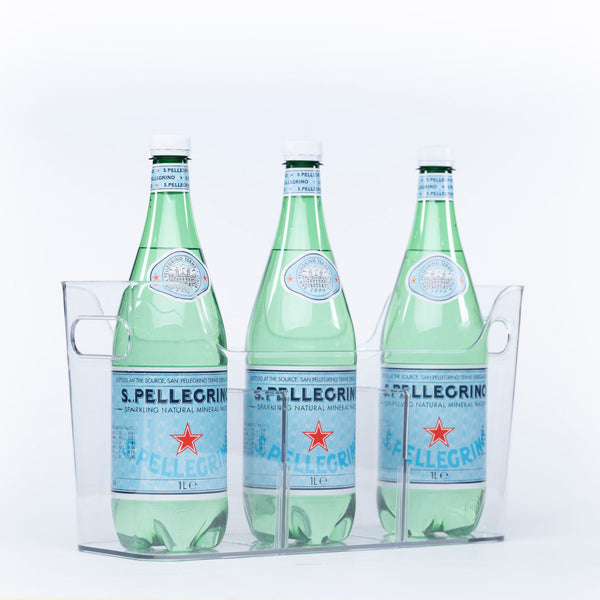 Three bottles of sparkling water stored in a clear Pull-Out Organiser, ideal for kitchen or pantry organisation.