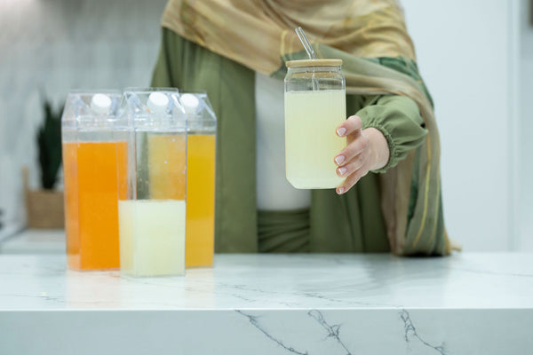 Alt Tag: Clear Drink Container – 1 Liter used in kitchen for pantry organisation, showcasing ideal storage for fresh juices. Glass jars nearby.