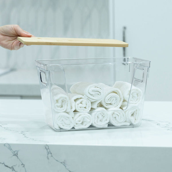Clear Storage Container with Bamboo Lid – 29cm holding rolled-up towels, ideal for bathroom or pantry organisation.