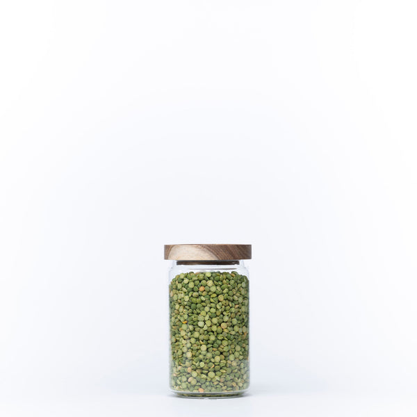 Round Glass Acacia Storage Jar filled with green peas, perfect for kitchen organisation and pantry storage solutions.