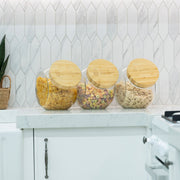 New Home Set Up Pack glass jars with bamboo lids for pantry storage on a kitchen bench