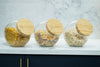 Round Tilt Glass Jar with Bamboo Lid – 4 L storing assorted cereals on kitchen counter, ideal for pantry organisation.