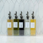 Glass Oil & Vinegar Bottles with Tray – 5 Pack displayed on kitchen counter for stylish pantry organisation.